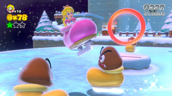 Prinzessin Peach springt auf einem zugefrorenen See in einem Schlittschuh durch einen Reifen. 