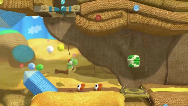Screenshot: Ein gestrickter Yoshi springt.